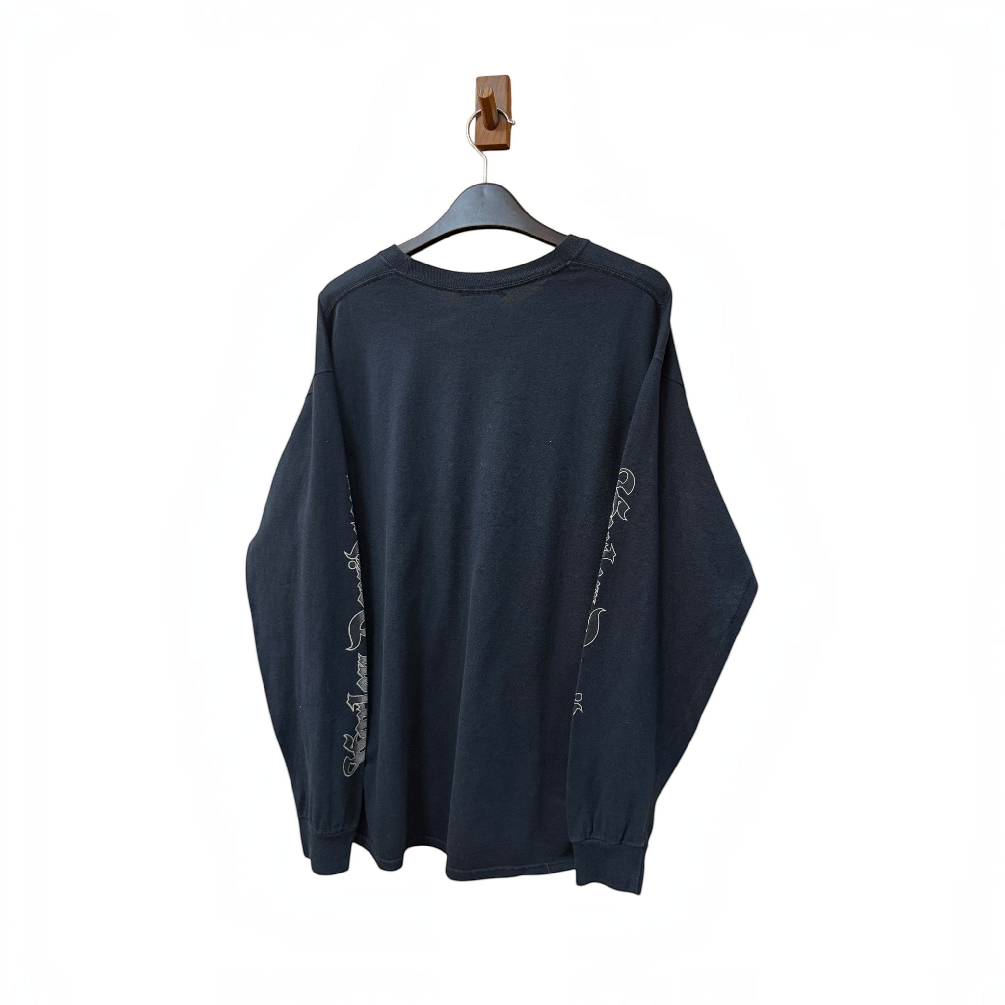 SILLYEGG VINTAGE black Harley Davidson long sleeve t-shirt with white sleeve graphics hanging on a wooden hook
